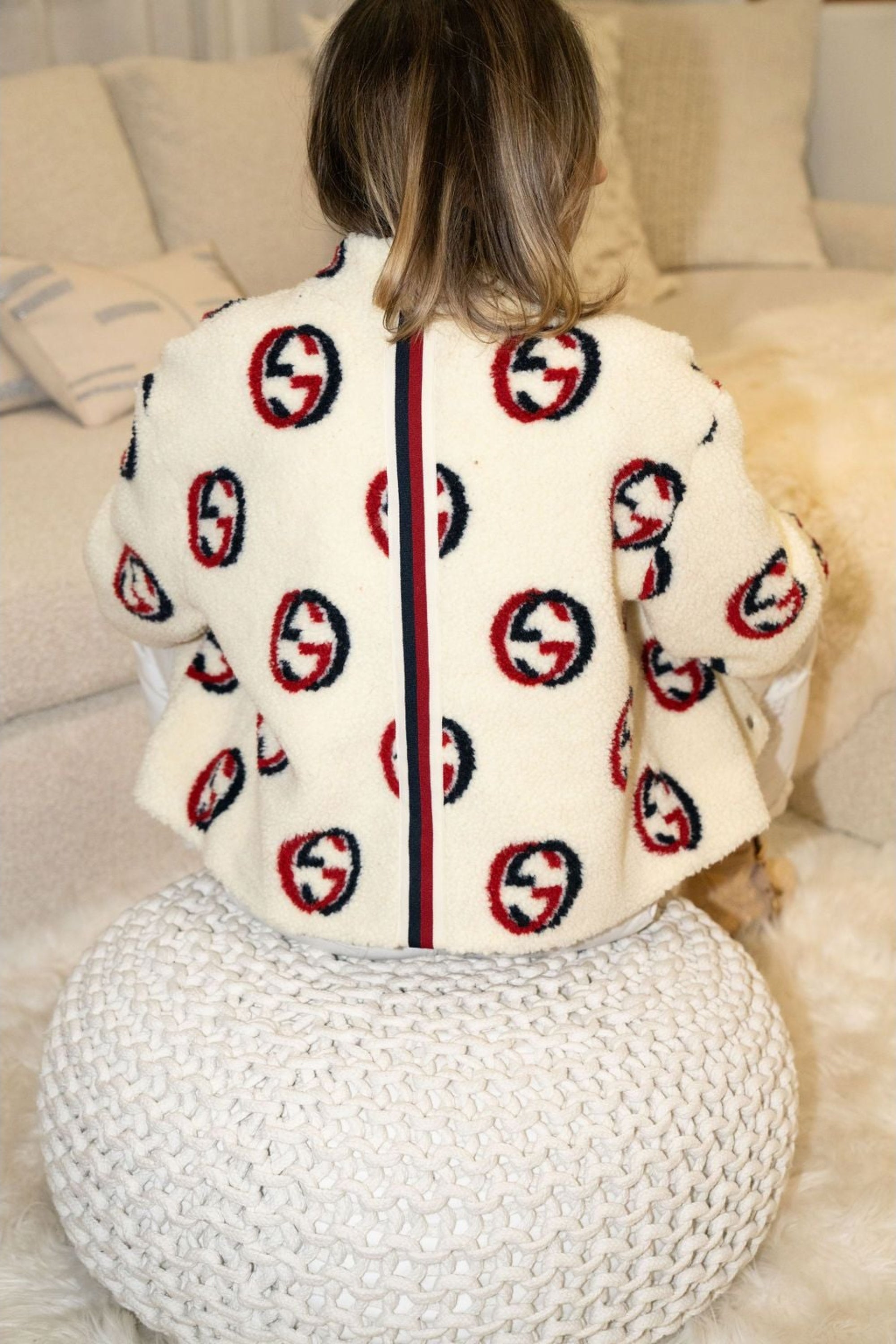 Woman wearing cream faux shearling bomber jacket with red and navy graphic print – Maru Bomber by Angel Wings by Lucy