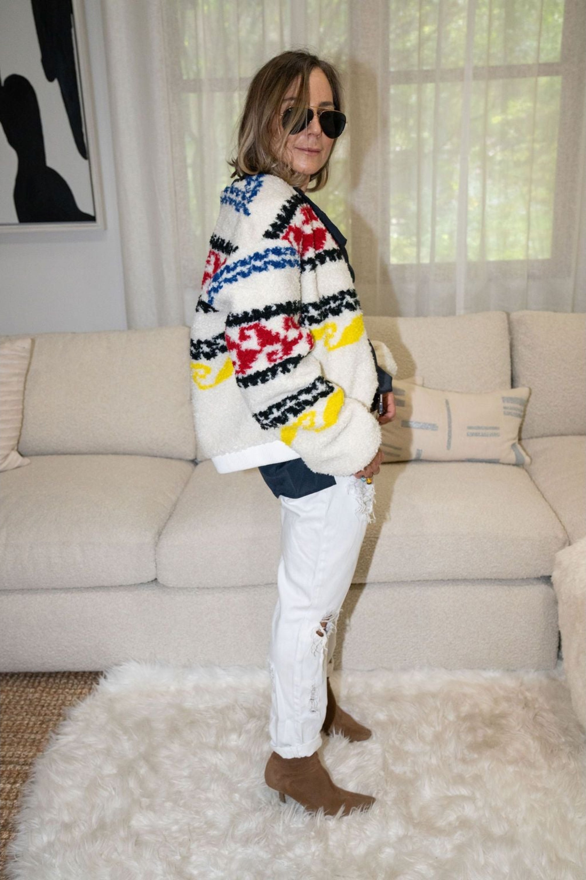 Woman wearing oversized Aztec faux shearling bomber jacket with white jeans – Bonnies Bomber by Angel Wings by Lucy
