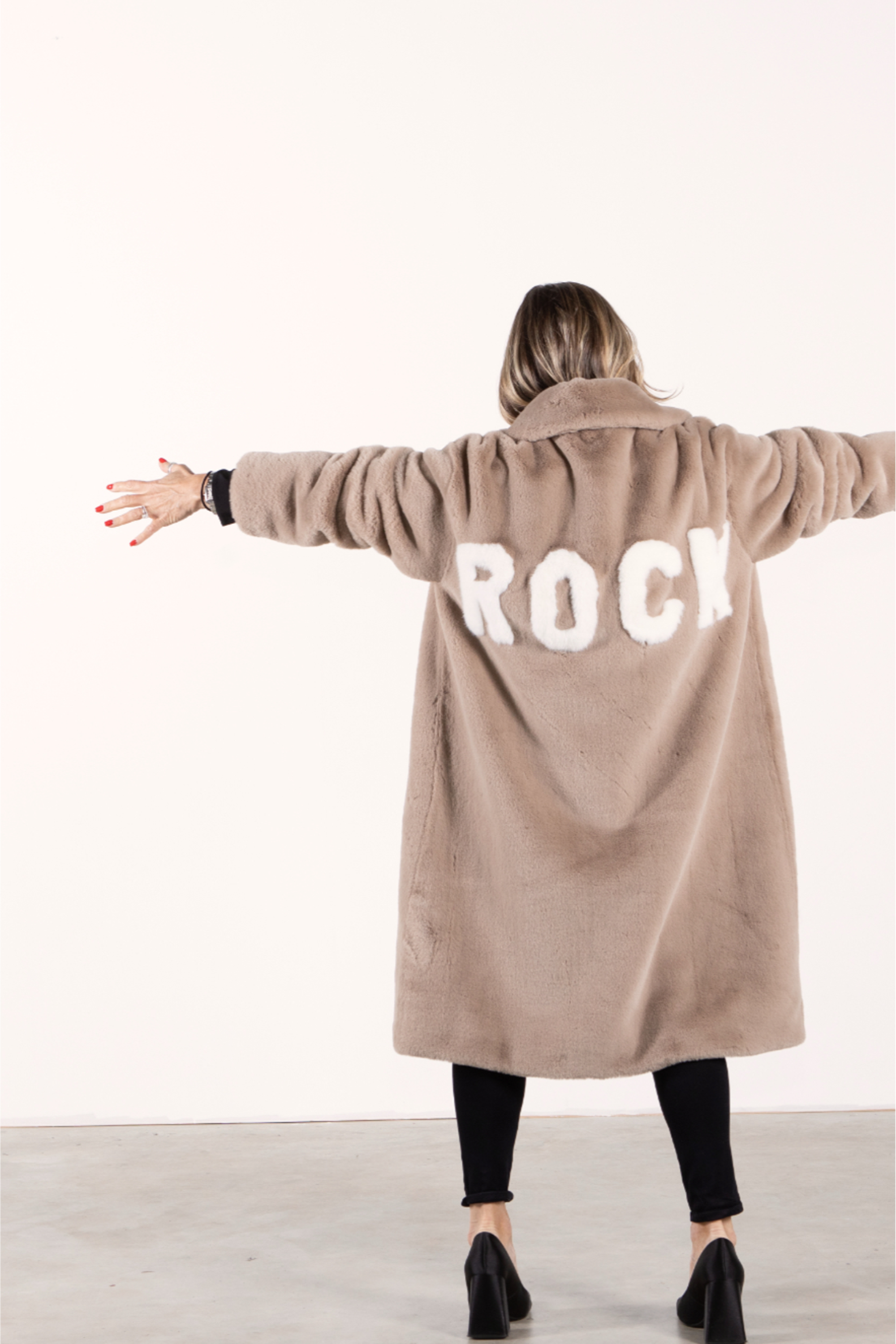 Angel Wings by Lucy Mr Greys ROCK Jacket – women’s luxury faux fur coat in mocca with bold ROCK lettering on back worn by Lucy MacGill Angel Wings founder