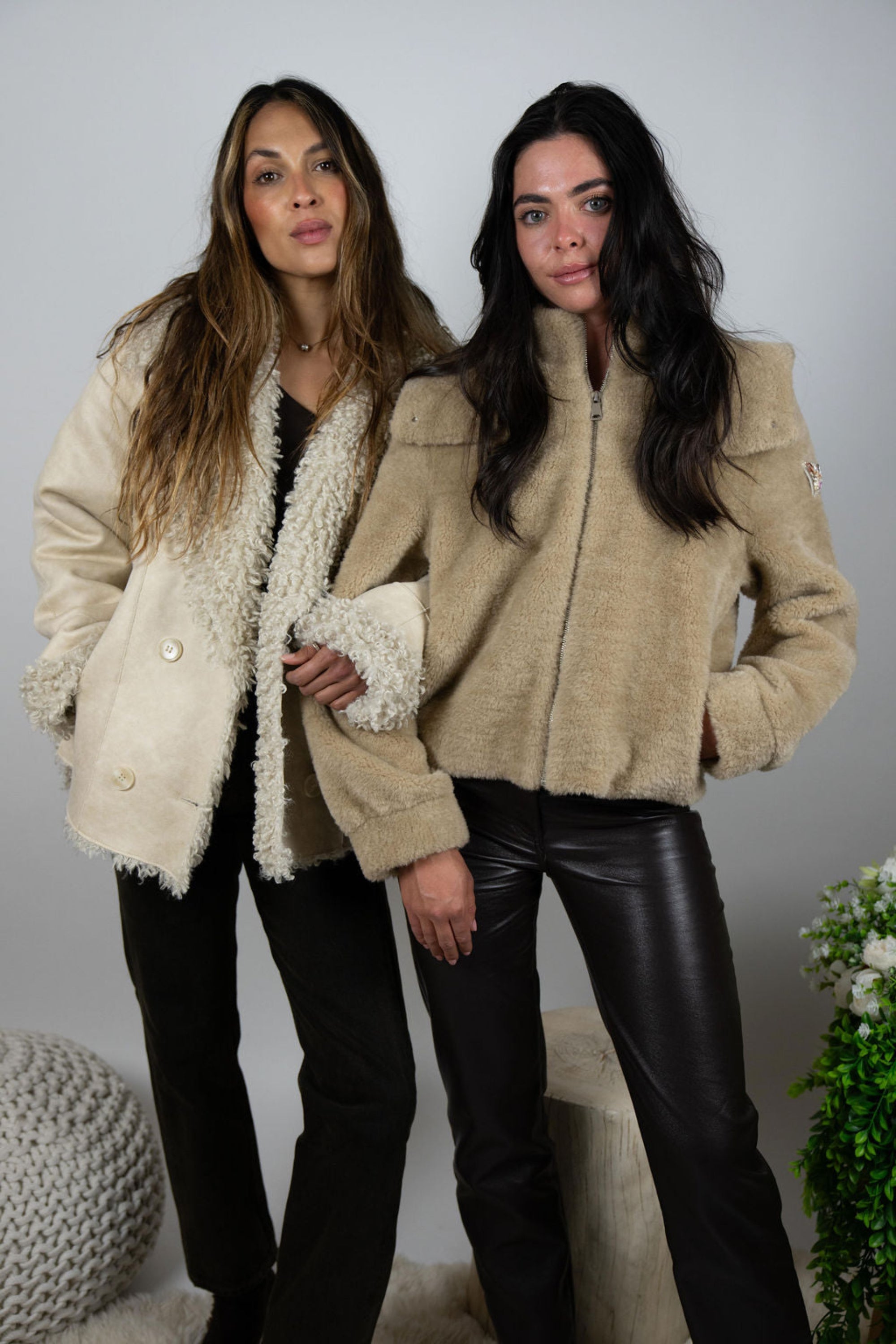 Two women wearing Angel Wings by Lucy faux fur jackets – Slope Room Bomber and cream jacket styled together for après-ski look