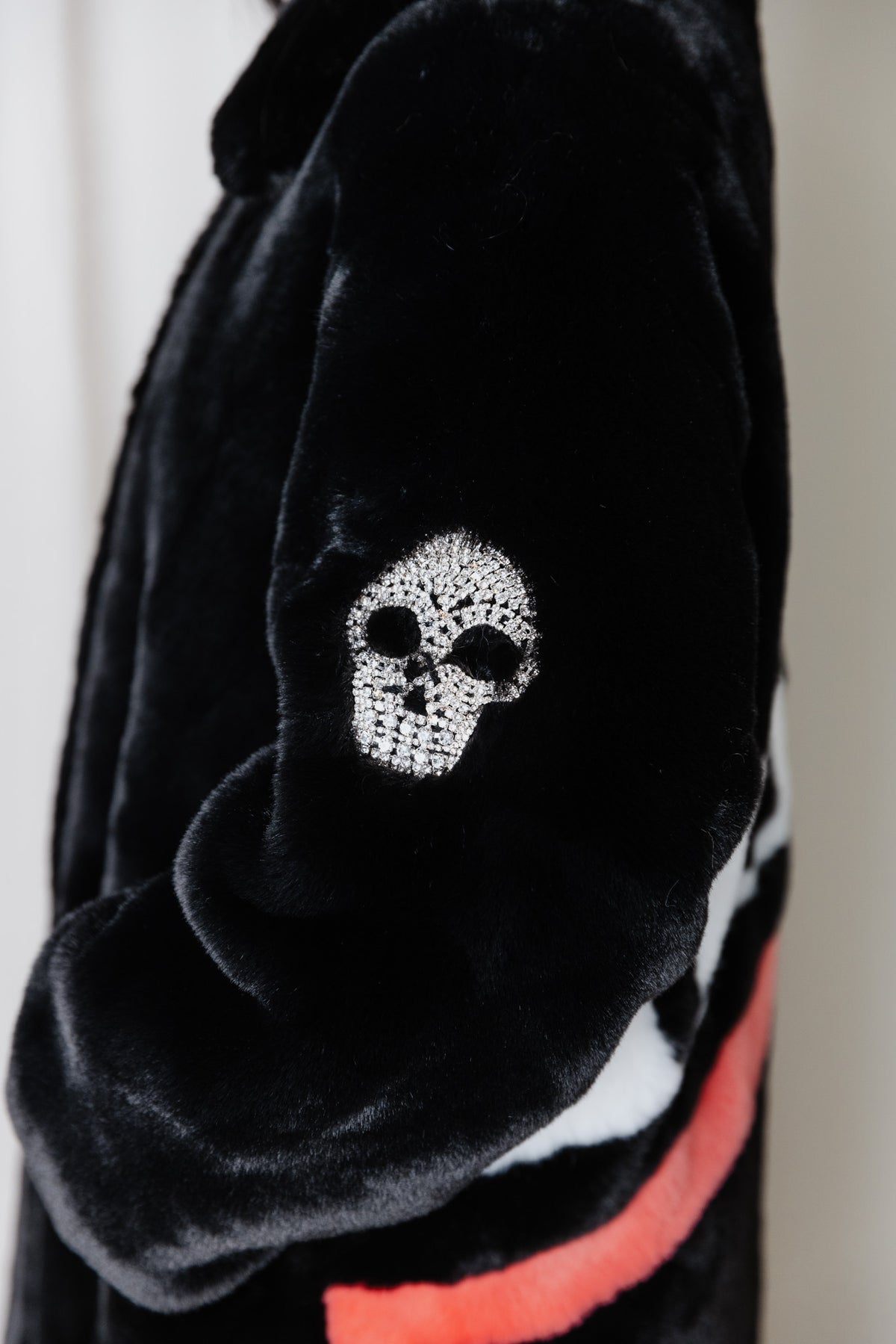 Crystal skull sleeve detail on the Angel Wings Mr Grey Love Skull black faux-fur coat.