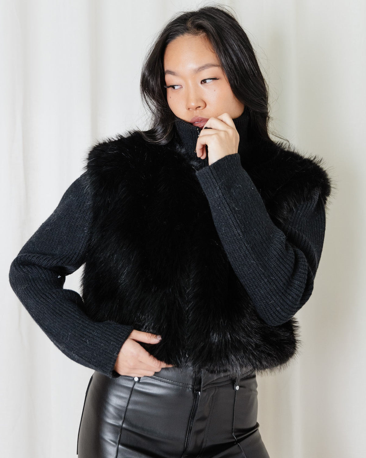 Angel Wings Snow Angel Knit in Black styled with leather pants, showing the textured faux-fur front and knit sleeves.