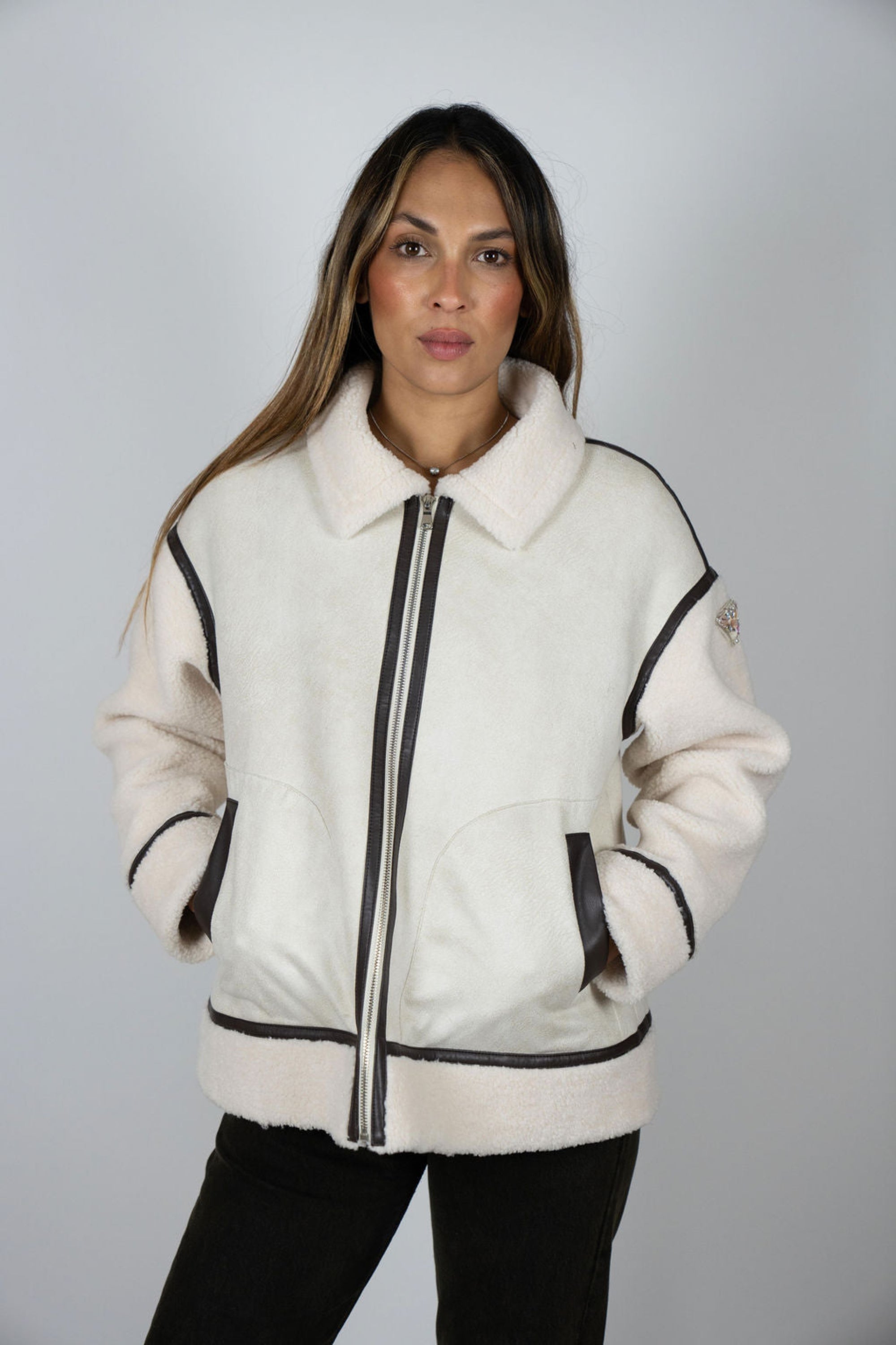 Model wearing Angel Wings by Lucy Vandetta Jacket in cream shearling with cocoa brown trim and collar