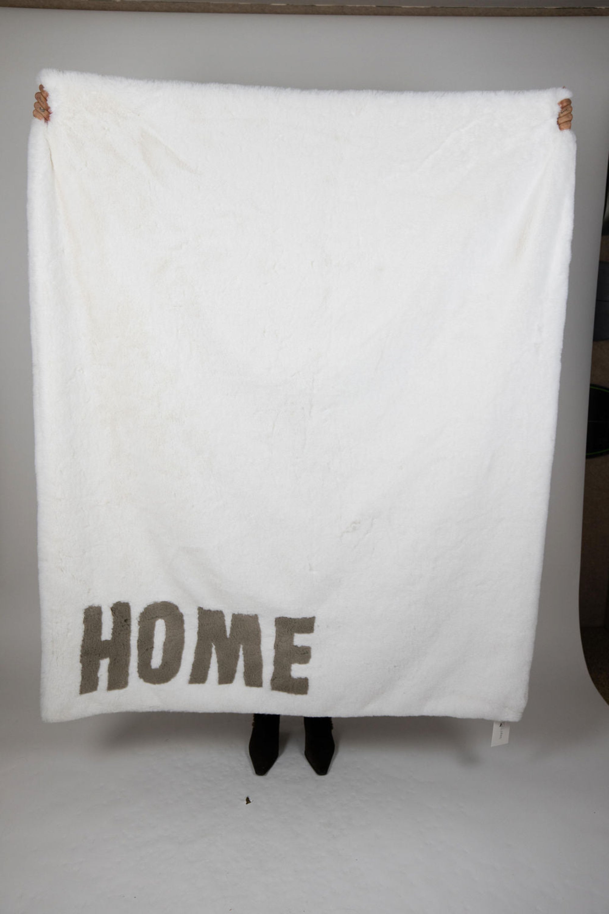 White faux fur throw blanket with bold HOME lettering in grey, size 60 x 80 inches – Angel Wings by Lucy