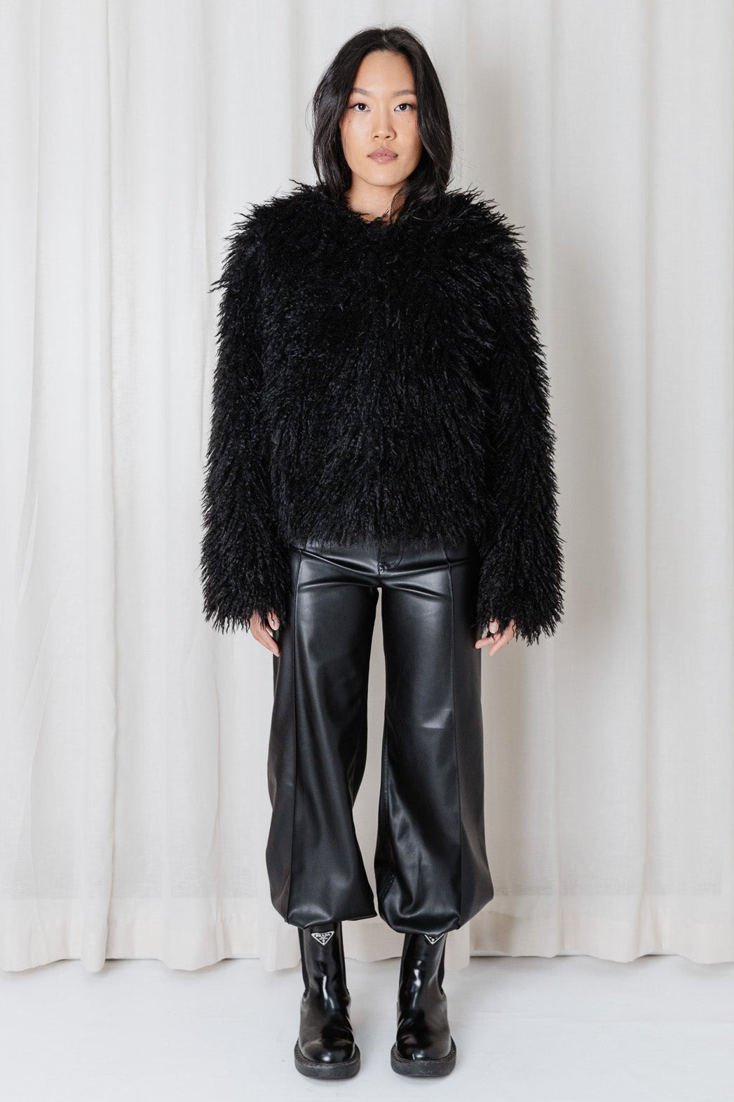 Front view of the Angel Wings Yeti Jacket in Black showing its long-pile faux-fur texture and hip-length fit.